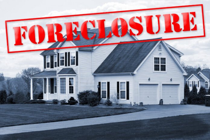 Non Judicial Foreclosure Large family house in black and white with a big red foreclosure stamped over it