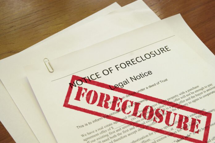 Foreclosure Pile of legal papers saying Legal Foreclosure with a big red stamped foreclosure on them