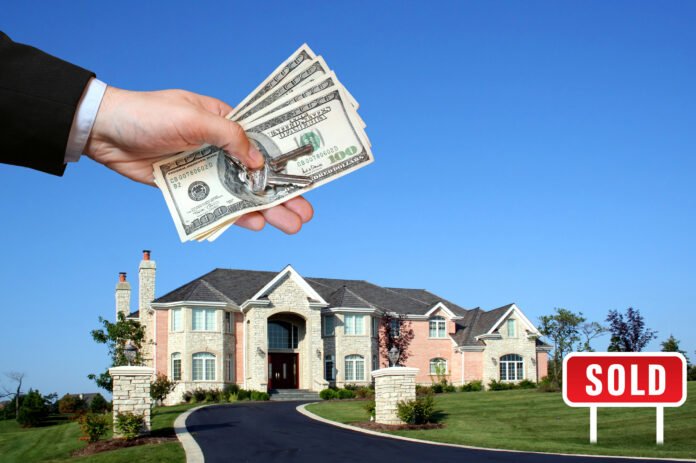 Seller Financing House with a hand above holding four hundred dollar bills