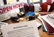 Mortgage vs Deed of Trust. What you need to know Real estate listing document sitting on a crowded desk with an open house sign