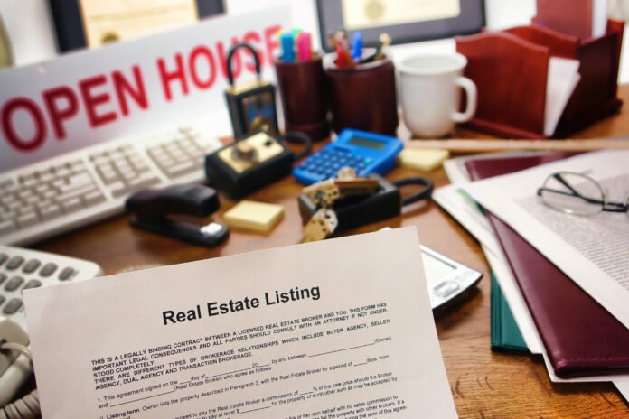 Mortgage vs Deed of Trust Real estate listing document sitting on a crowded desk with an open house sign