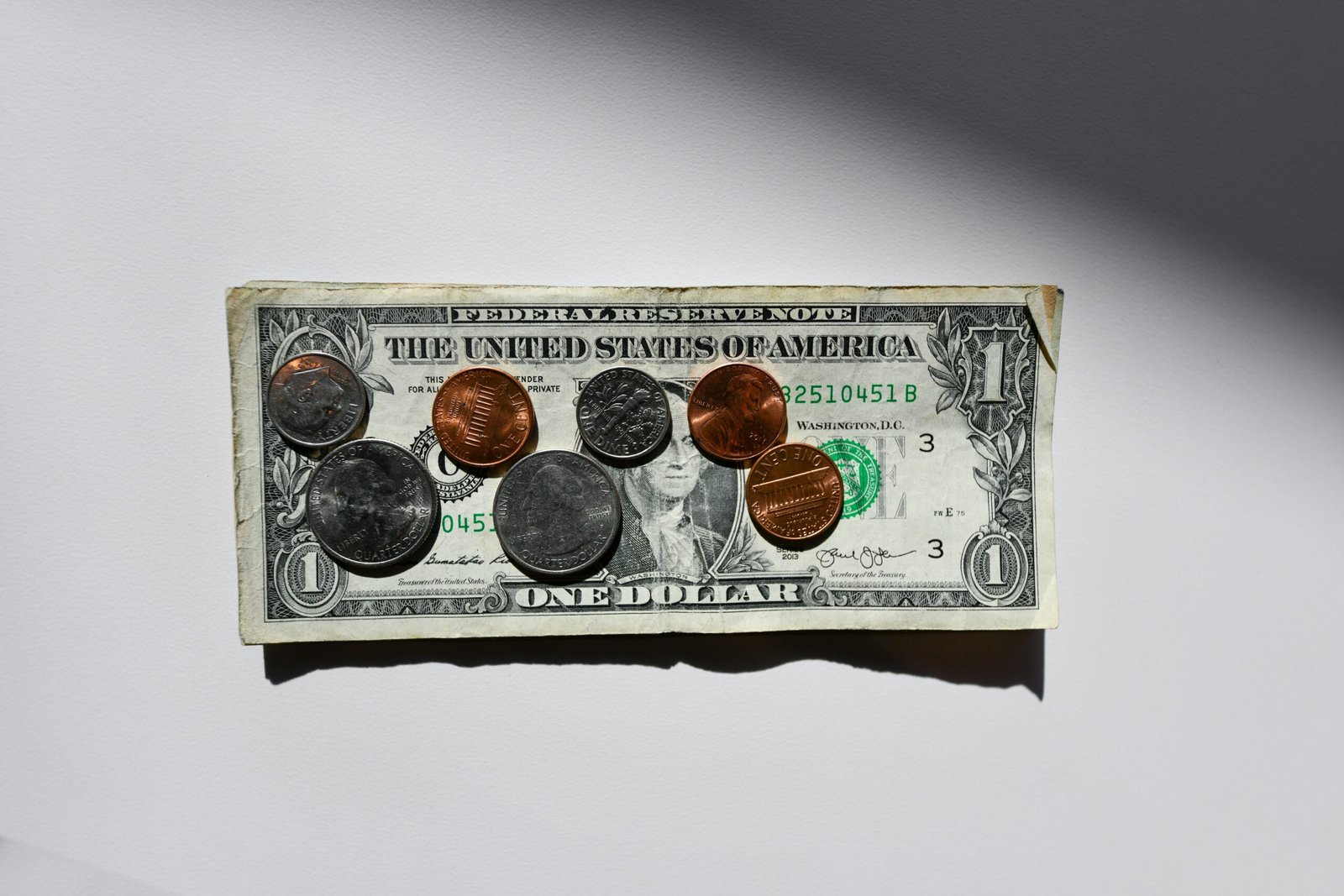 silver and gold coins on a dollar note silver and gold round coins in box